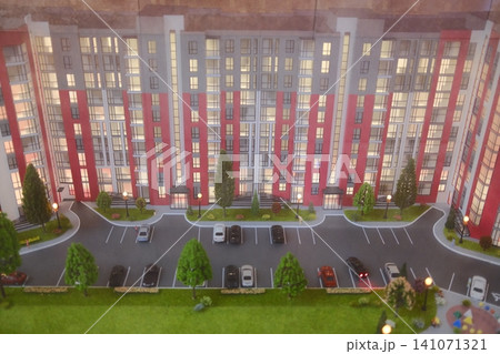 Model of a building, trees, parking spaces, and cars are displayed Model of a building, trees, parking spaces, and cars are displayed 141071321