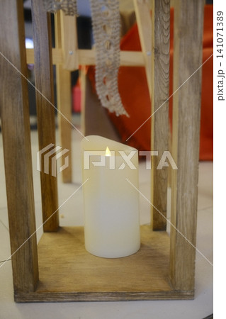 Candle burns brightly inside a decorative lantern 141071389