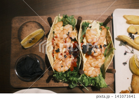 Two fresh shrimp tacos with crisp lettuce, creamy sauce Two fresh shrimp tacos with crisp lettuce, creamy sauce 141071641