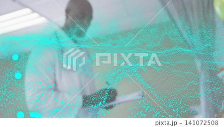 Standing doctor in white lab coat reviewing tablet with stethoscope in clinic, turquoise data-wave Standing doctor in white lab coat reviewing tablet with stethoscope in clinic, turquoise data-wave 141072508