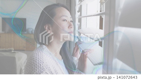 Parting shutters, Korean woman in light knit cardigan gazing outside in home colorful wave crossing 141072643