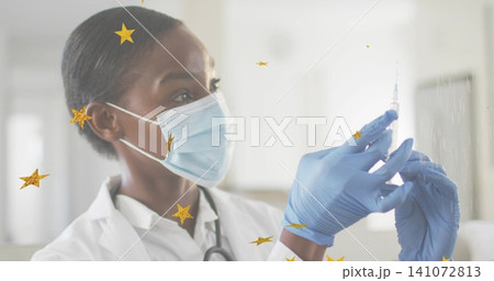 Holding syringe, nurse drawing med in exam room, in lab coat, mask, stethoscope, gloves, gold stars Holding syringe, nurse drawing med in exam room, in lab coat, mask, stethoscope, gloves, gold stars 141072813