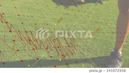 Stepping lower-half in shorts and sneakers on sunny turf, red grid and yellow markers, copy space 141072938