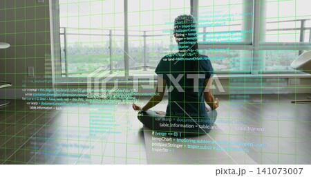 Sitting Asian woman wearing dark tee, meditating on floor in studio facing city, code grid overlay Sitting Asian woman wearing dark tee, meditating on floor in studio facing city, code grid overlay 141073007