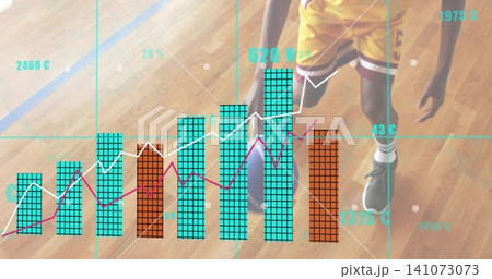 Standing teen player wearing yellow kit holding basketball on wood court showing teal orange charts Standing teen player wearing yellow kit holding basketball on wood court showing teal orange charts 141073073