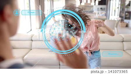 Stepping woman wearing tied pink shirt, denim shorts reacting to blue AR interface in living room 141073365