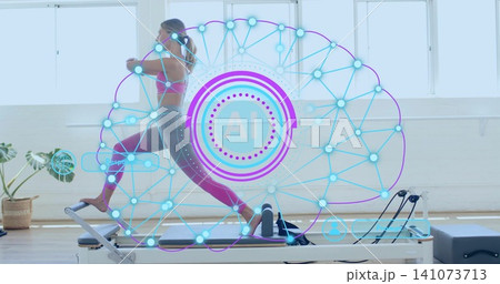 Lunging woman in pink sports bra magenta leggings on Pilates reformer at studio with AI overlay 141073713