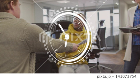 Receiving man wearing yellow hoodie, team handing paper and holding tablet in office clock overlay 141073754