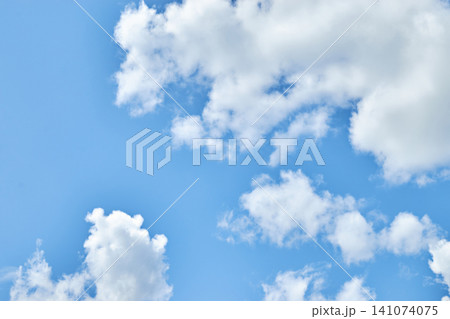 Fluffy white clouds in blue sky. Cumulus cloudscape texture. Sunny summer sky background. Fluffy white clouds in blue sky. Cumulus cloudscape texture. Sunny summer sky background. 141074075