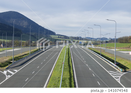 Empty wide highway with multi lane asphalt road Empty wide highway with multi lane asphalt road 141074548