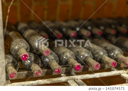 Storing vintage wine bottles in a dusty cellar 141074571