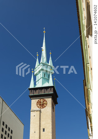 ZNOJMO town hall clock tower spire against blue sky ZNOJMO town hall clock tower spire against blue sky 141074602