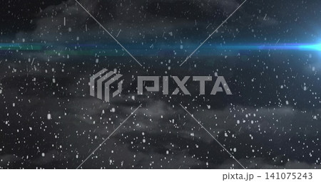 Falling snowflakes forming streaks through low fog at night, showing blue flare with cyan point Falling snowflakes forming streaks through low fog at night, showing blue flare with cyan point 141075243