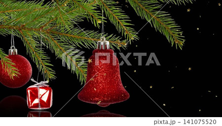 Hanging red glitter bell gleaming under fir branch, reflecting on glossy surface with red bauble Hanging red glitter bell gleaming under fir branch, reflecting on glossy surface with red bauble 141075520