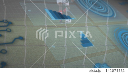 Showing goal net, players controlling soccer ball on goal line in white kit with AR overlays 141075581