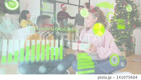 Exchanging children in pink and mustard shirts passing wrapped gift at home with green overlays 141075684