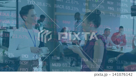 Chatting two women wearing business wear and lanyards with cups in office breakroom, ticker overlay Chatting two women wearing business wear and lanyards with cups in office breakroom, ticker overlay 141076142