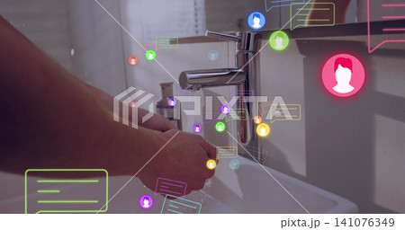 Washing adult hands under chrome faucet at bathroom sink, showing soap dispenser and messages Washing adult hands under chrome faucet at bathroom sink, showing soap dispenser and messages 141076349