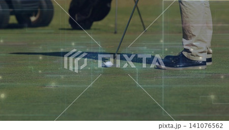 Placing golfer's legs, putting putter behind golf ball on green, khaki pants, navy shoes, overlays Placing golfer's legs, putting putter behind golf ball on green, khaki pants, navy shoes, overlays 141076562