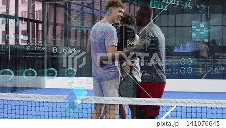 Chatting players wearing sportswear, shaking hands at net on blue court with paddle and AR overlays 141076645