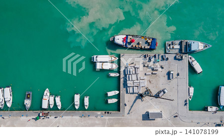 Aerial view of tour boats and logistic boats parking over turquoise water in the jetty 141078199