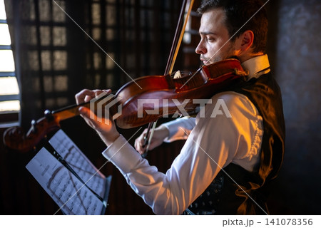Close up portrait of a man playing violin Close up portrait of a man playing violin 141078356