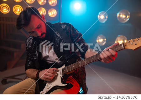 Close up of a guitar player practicing chords Close up of a guitar player practicing chords 141078370