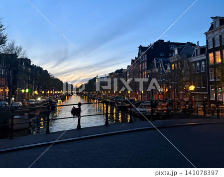 Traditional building and canal at night in Amsterdam Netherlands Traditional building and canal at night in Amsterdam Netherlands 141078397