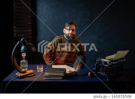 Portrait of a bearded writer sitting at his desk Portrait of a bearded writer sitting at his desk 141078506