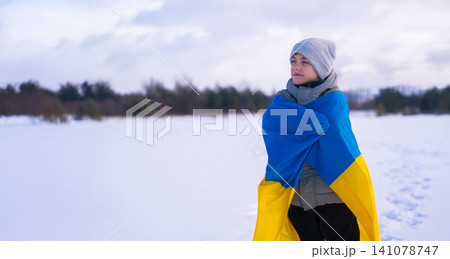Happy Little Boy Ukrainian Patriot Child With National Flag On Winter Snow Background 141078747