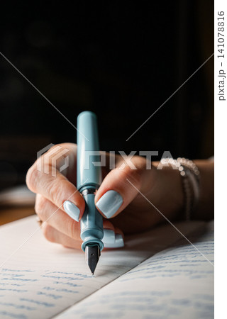 Woman Writing Notes In Notebook With Blue Fountain Pen, Focus And Planning Woman Writing Notes In Notebook With Blue Fountain Pen, Focus And Planning 141078816