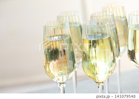 Glasses of champagne on blurred background, closeup view 141079548