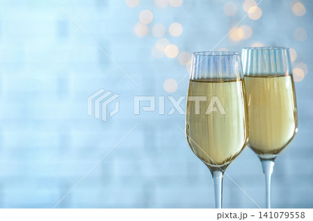 Glasses of champagne against blurred lights. Space for text 141079558