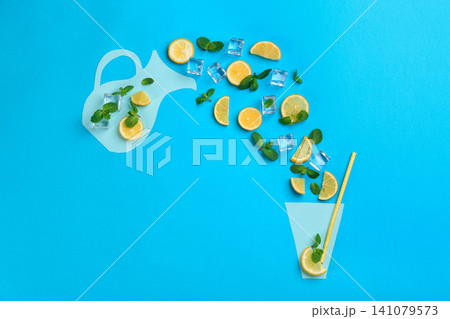 Creative lemonade layout with lemon slices, mint and ice on blue background, top view 141079573