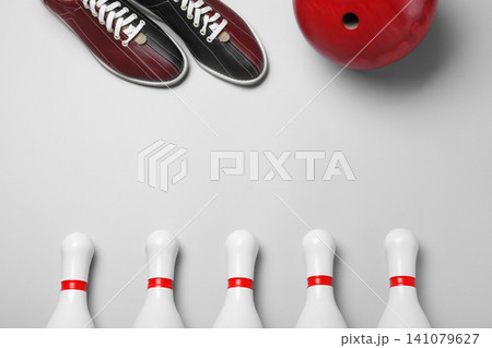 Bowling ball, shoes and pins on white background, flat lay Bowling ball, shoes and pins on white background, flat lay 141079627