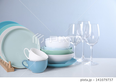 Set of clean tableware on light table Set of clean tableware on light table 141079737