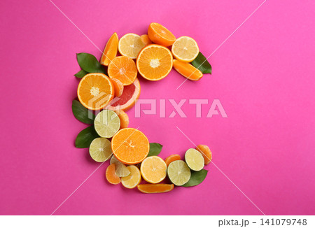 Letter C made with citrus fruits on pink background as vitamin representation, flat lay Letter C made with citrus fruits on pink background as vitamin representation, flat lay 141079748