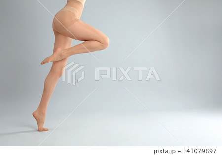 Woman wearing black tights and stylish shoes on light grey background, closeup of legs Woman wearing black tights and stylish shoes on light grey background, closeup of legs 141079897