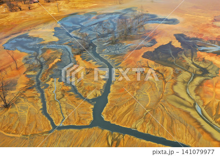 Aerial view of surreal toxic water stream from copper mine in decanting lake. Natural pattern Aerial view of surreal toxic water stream from copper mine in decanting lake. Natural pattern 141079977