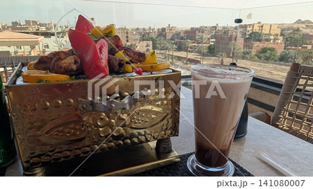 Close up of grilled kebab mix and a glass of iced mocha Close up of grilled kebab mix and a glass of iced mocha 141080007