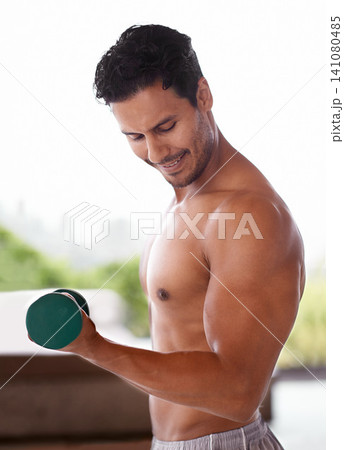 Muscle, dumbbell and happy man outdoor for training, exercise and sports to workout for power. Bodybuilder, strong and topless person weightlifting for fitness, health or wellness with abs in nature 141080485