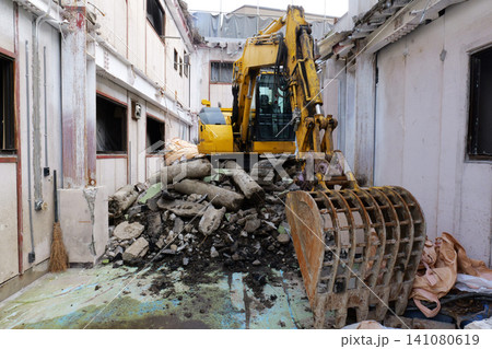 Bulldozer Demolishing Old Building at Construction Site in Japan 141080619