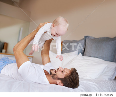 Love, smile and baby with father on bed relaxing, playing and bonding together at home. Happy, sweet and young dad laying with girl child, infant or kid in bedroom or nursery at family house. Love, smile and baby with father on bed relaxing, playing and bonding together at home. Happy, sweet and young dad laying with girl child, infant or kid in bedroom or nursery at family house. 141080639