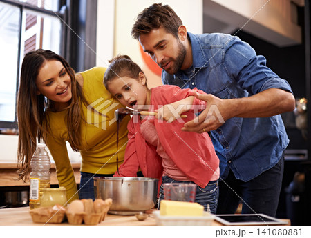 Parents, girl and kitchen for baking with love, ingredients for cake or dessert with support and handmade with care. Mom, dad and kid with wow face for mixture with bonding or teaching with affection Parents, girl and kitchen for baking with love, ingredients for cake or dessert with support and handmade with care. Mom, dad and kid with wow face for mixture with bonding or teaching with affection 141080881
