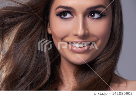 Thinking, shine and glow with woman, hair care and aesthetic on grey studio background. Person, wellness and treatment with girl or model with texture and volume with healthy scalp, growth or shampoo 141080902