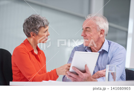 Tablet, happy team and mature business people planning, discussion or brainstorming strategy in office together. Manager, man and woman in collaboration on tech for research of financial consultants 141080903