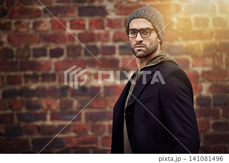 Man, portrait and urban fashion by brick wall downtown for aesthetic, modern and expression for city culture. Male person, trendy winter outfit for streetwear style for creative career in retail Man, portrait and urban fashion by brick wall downtown for aesthetic, modern and expression for city culture. Male person, trendy winter outfit for streetwear style for creative career in retail 141081496