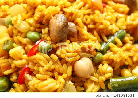 Delicious rice pilaf with vegetables as background, closeup 141081631