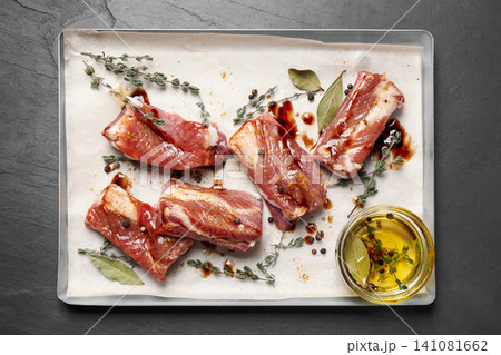 Raw marinated ribs on black table, top view 141081662
