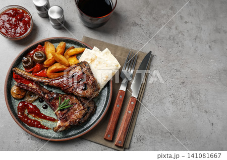 Delicious grilled ribs served on light grey table, flat lay. Space for text 141081667